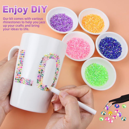 A multicolored resin flatback rhinestone bedazzling kit with tools.